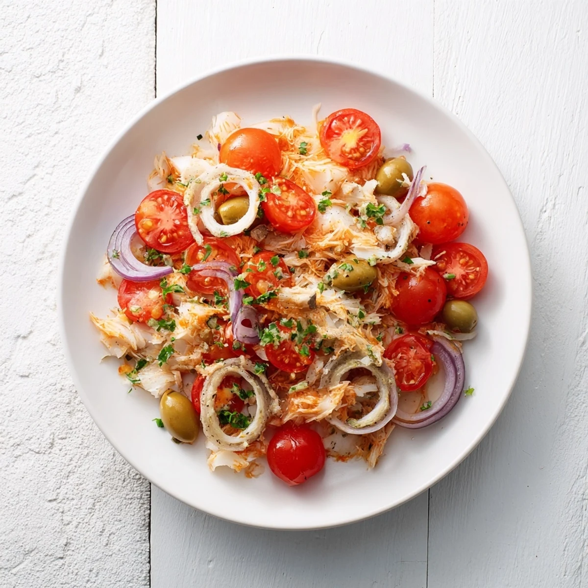Golden-brown One-Tray Baked Cod with juicy tomatoes, olives, and herbs, perfect for dinner.