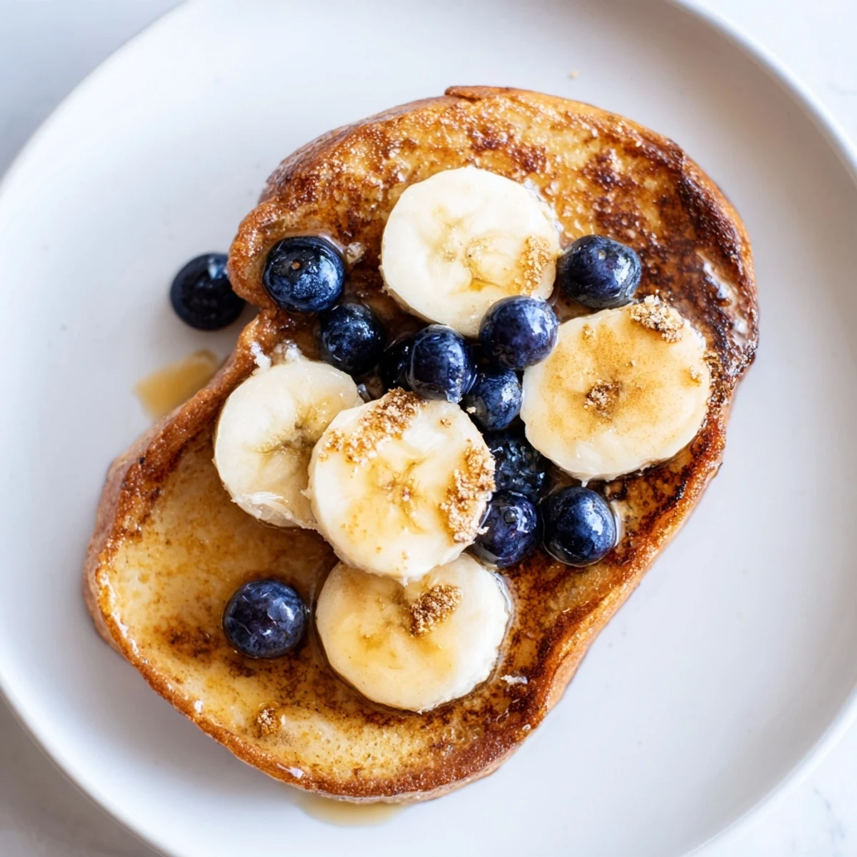 Golden-brown Protein French Toast, topped with fresh berries, promises a delightful, protein-packed breakfast.