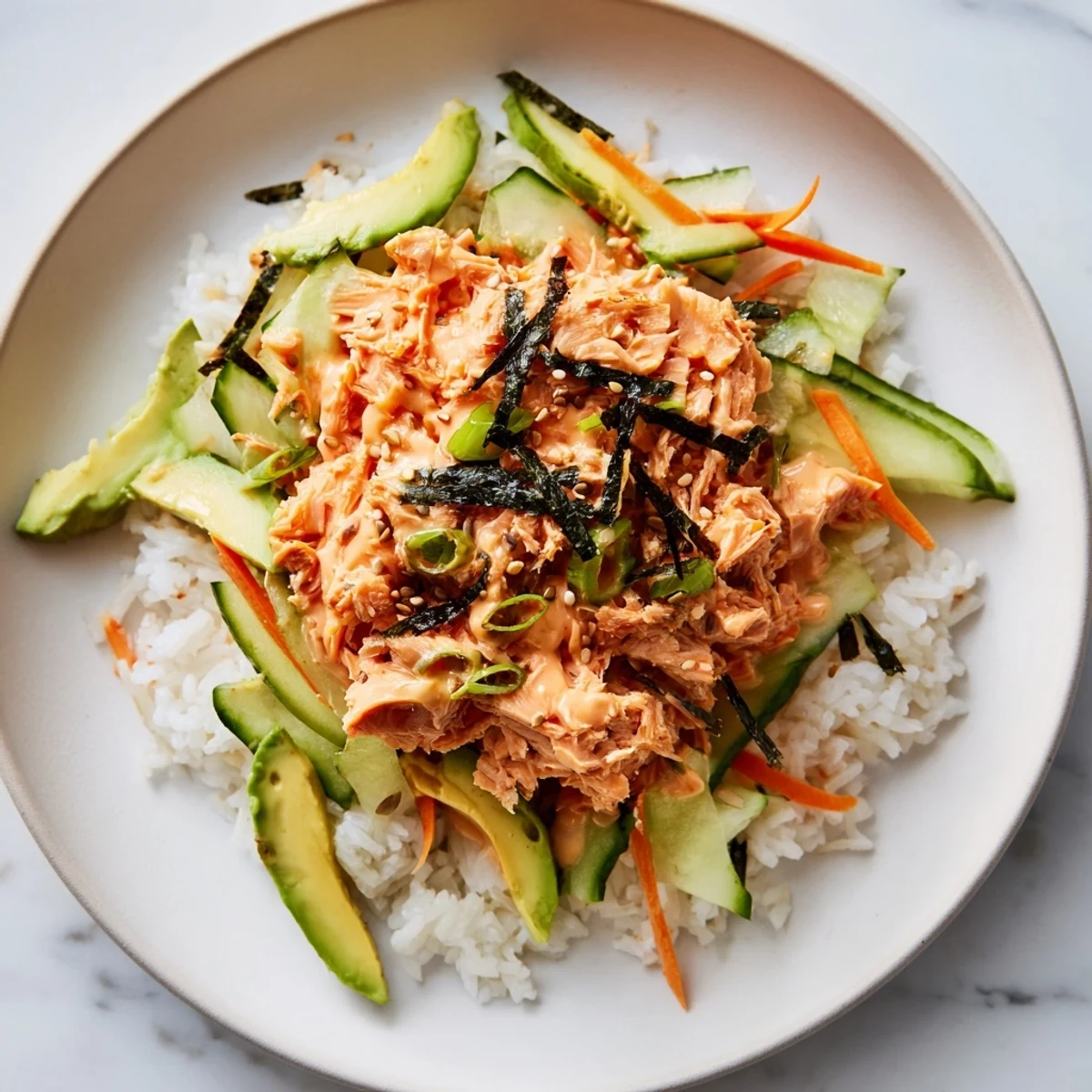 Steaming Spicy Canned Salmon Rice Bowl ready to eat, with colorful veggies and creamy sriracha mayo.