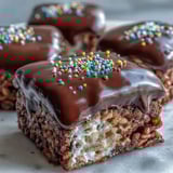 Golden-brown Rice Krispy Treats layered with rich, velvety melted chocolate, ideal for homemade gifts or holiday trays.