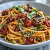 Tossing spaghetti with a rich Chianti tomato sauce and onions for a bold fusion meal.