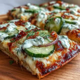 Pickle Pizza Flatbread with garlic ranch: tangy pickles atop melty cheese.
