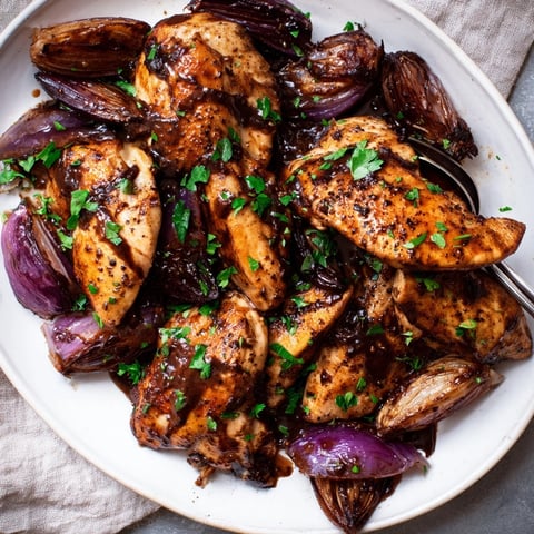 One-Pan Balsamic Glazed Chicken and Red Onions served golden with caramelized edges in a skillet.