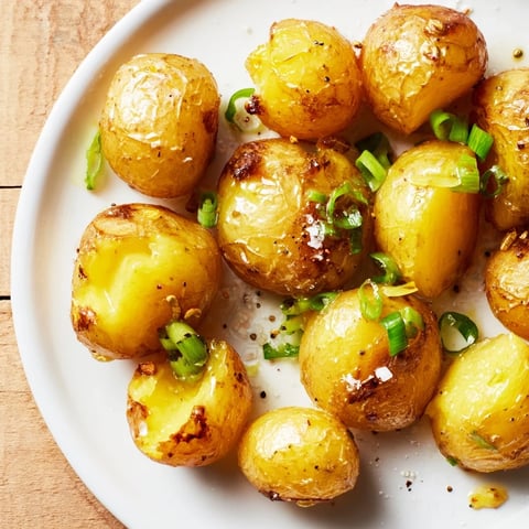 Golden, crispy Smashed Green Onion Potato Bombs, a delicious vegetarian side dish sizzling hot from the oven.