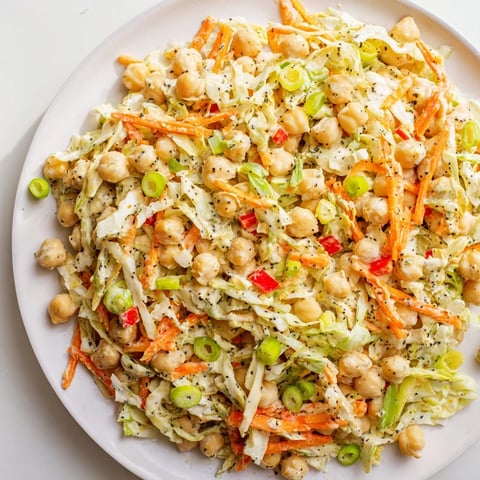 Vibrant chickpea salad tossed in creamy tahini-lemon dressing, perfect for a light, healthy lunch.