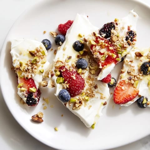 Beautiful, colorful mixed berries topping smooth yogurt in this easy Berry Yogurt Bark recipe.