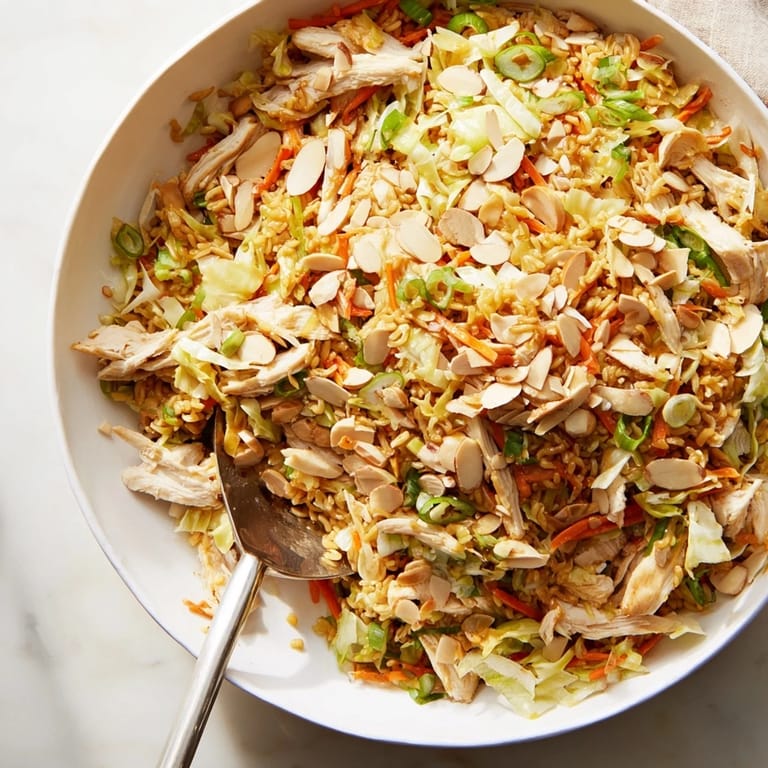 Shredded carrots, toasted almonds, and fresh scallions mix with savory chicken in this refreshing Crunchy Ramen Chicken Salad.