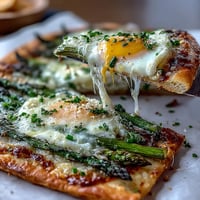 Crispy Asparagus and Egg Flatbread with melted parmesan, perfect for brunch.