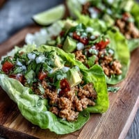 Juicy {{Turkey Taco Lettuce Wraps (Low Carb)}} piled high in crisp leaves.